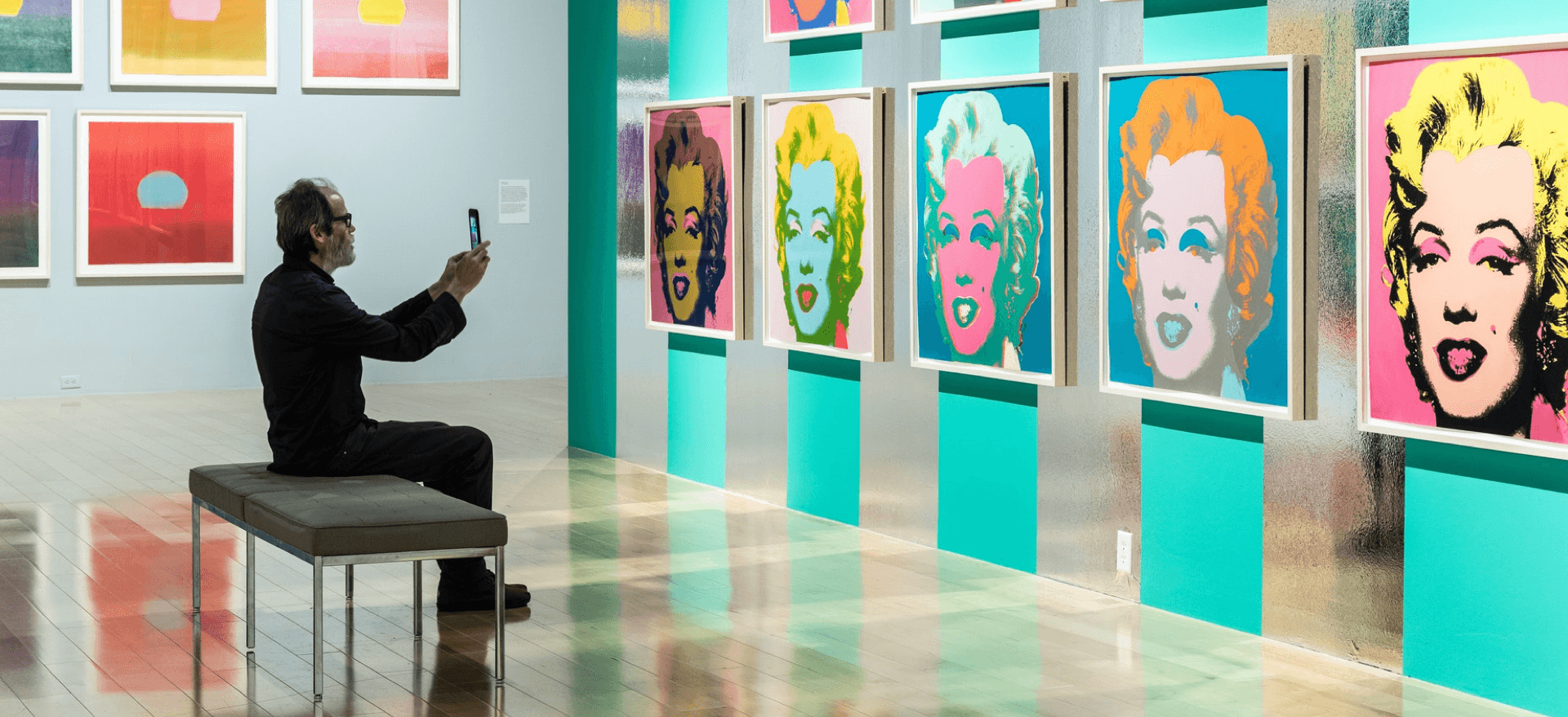 A museum visitor looking at artworks.